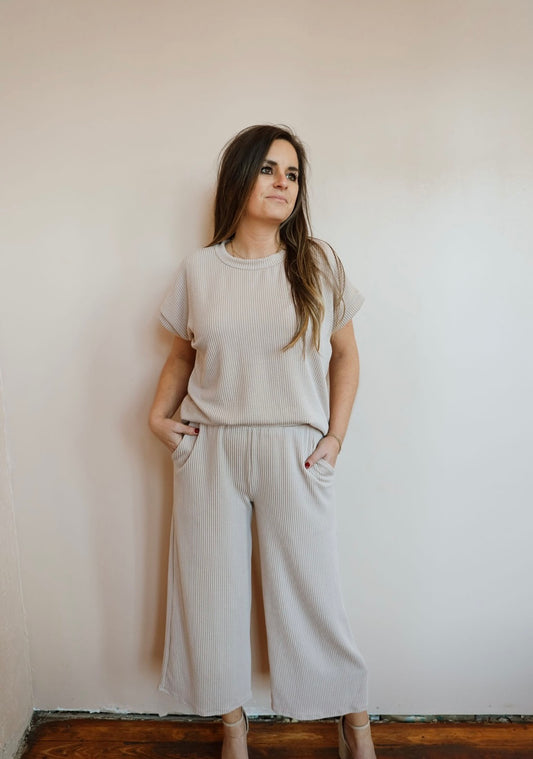 Beige Ribbed Two Piece Short Sleeve Pants Set: Comfortable and versatile outfit. Dress up with heels or down with sneakers/sandals. Perfect for everyday wear or going out. Pair with a jacket for cooler days. True-to-size fit.