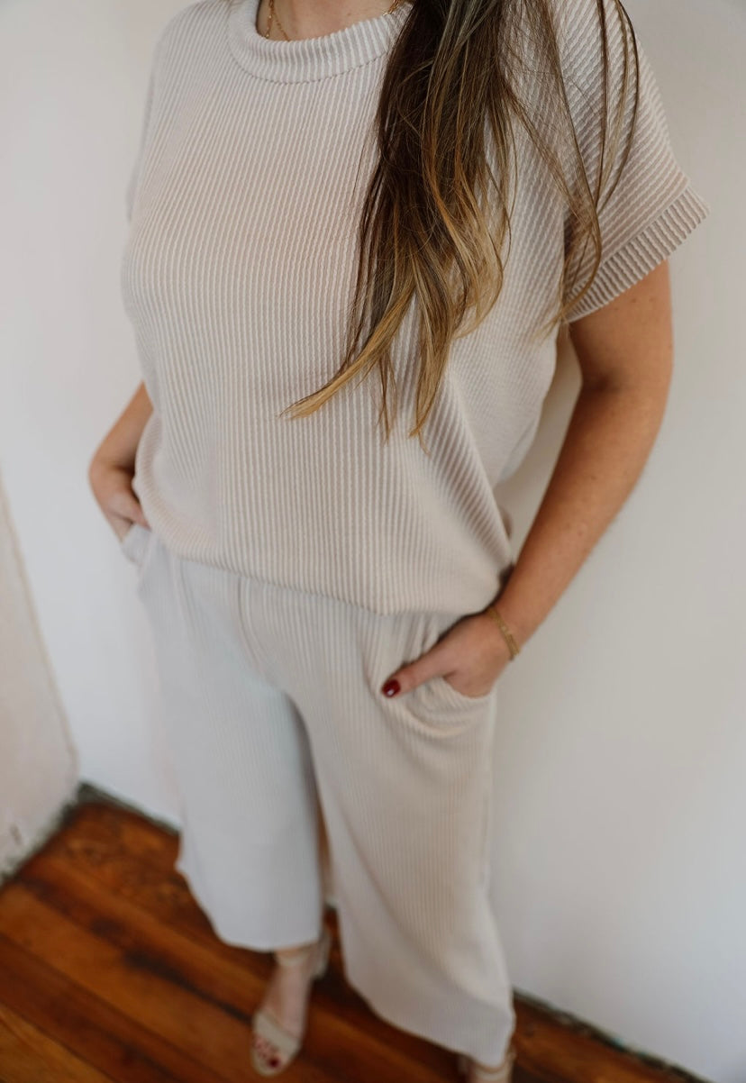 Beige Ribbed Two Piece Short Sleeve Pants Set: Comfortable and versatile outfit. Dress up with heels or down with sneakers/sandals. Perfect for everyday wear or going out. Pair with a jacket for cooler days. True-to-size fit.